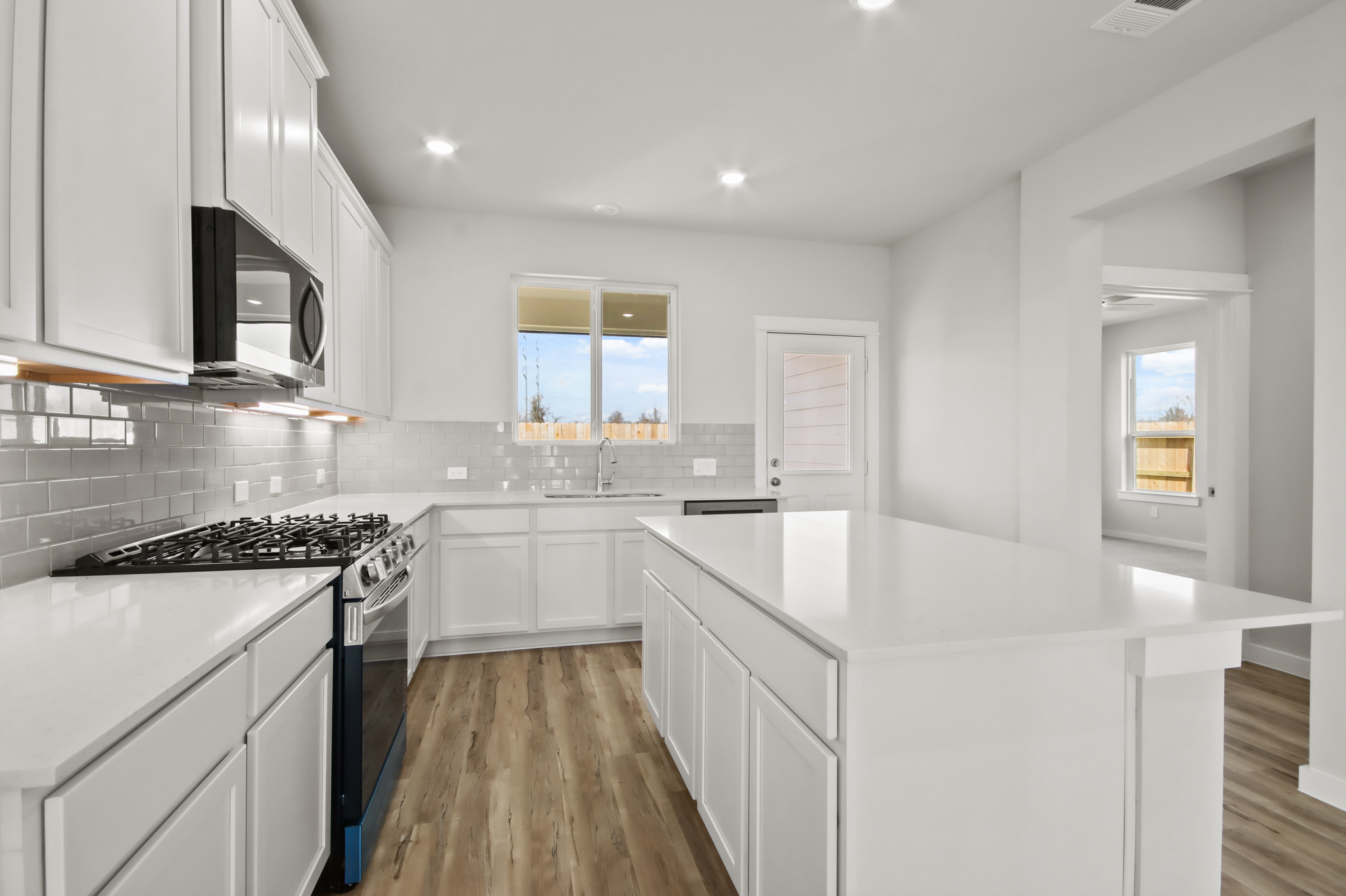 A kitchen with white cabinets.