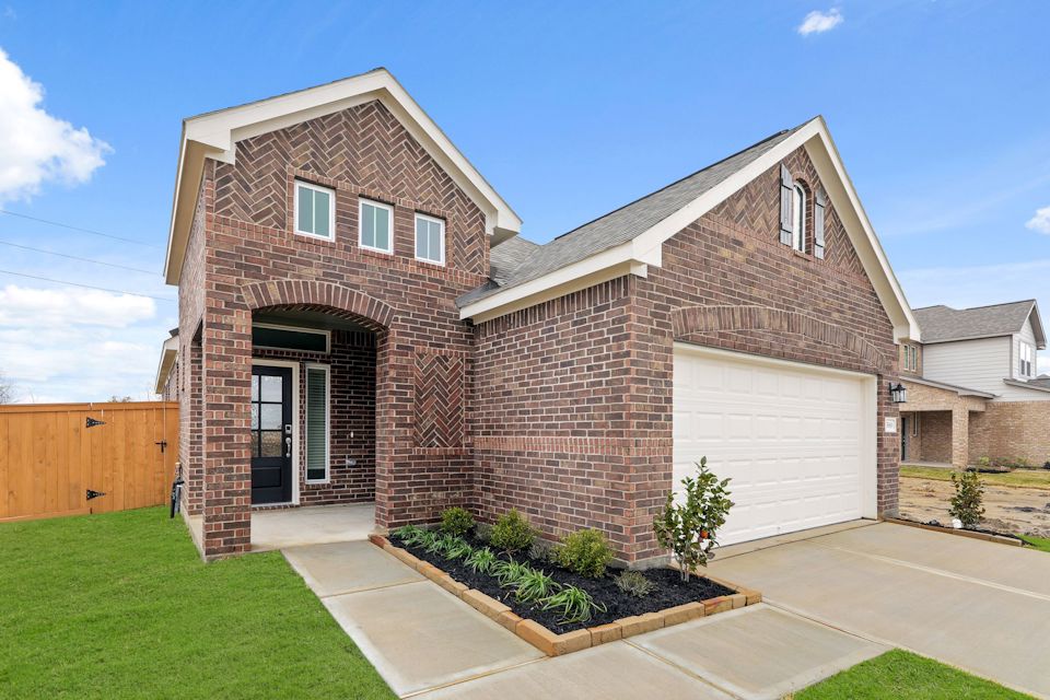 A brick house with a garage.