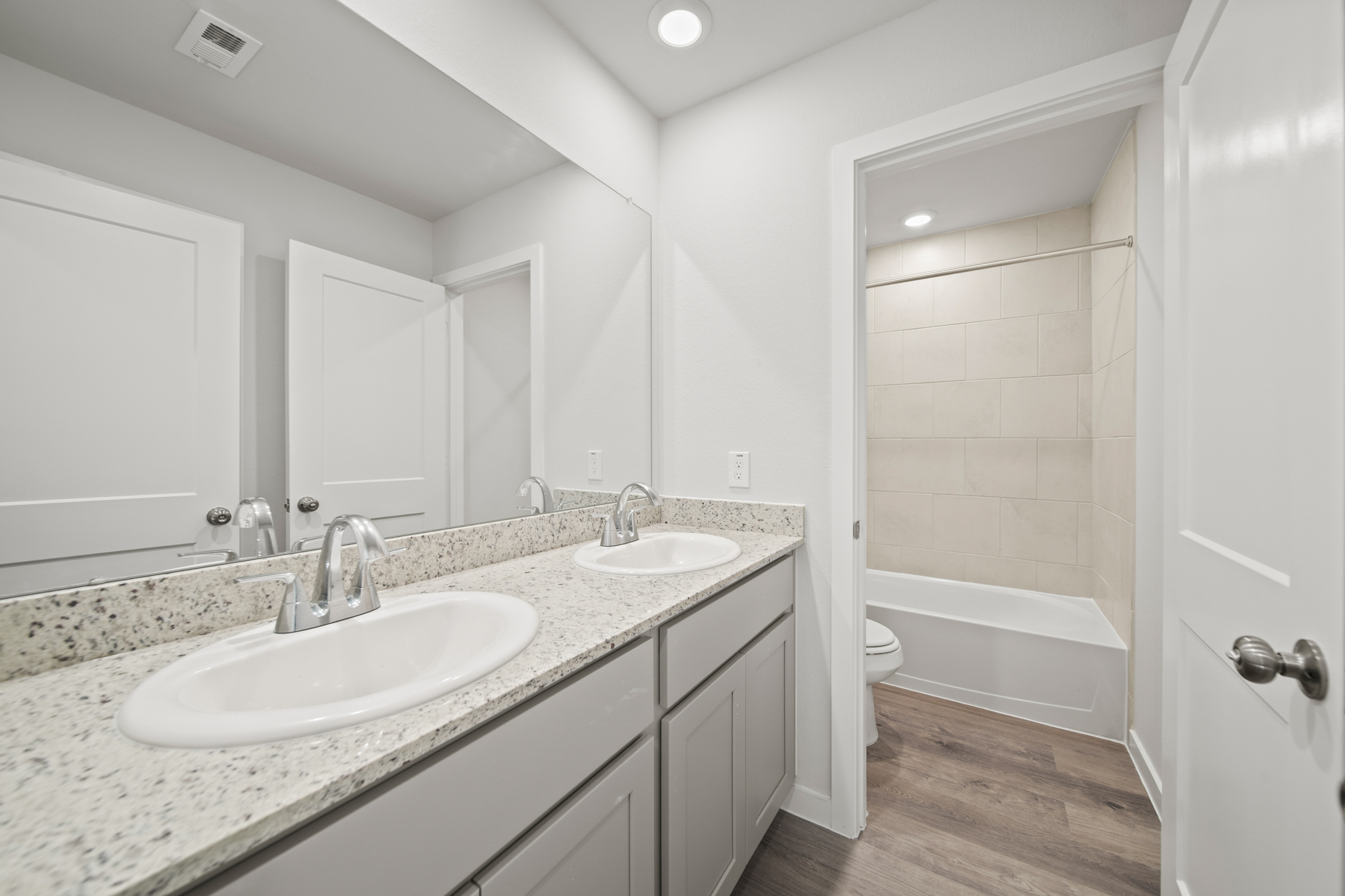 A bathroom with a tub sink and a toilet.
