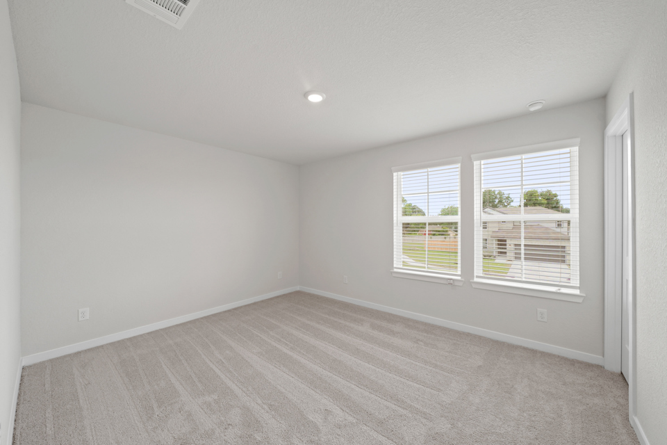 A room with a window and a carpet.