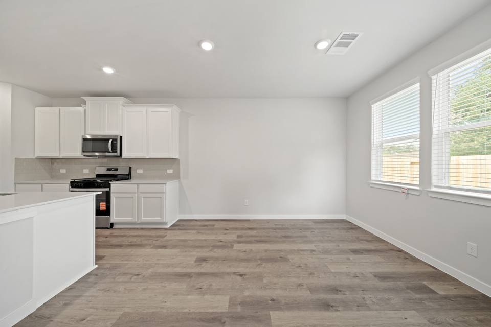 A kitchen with white cabinets.