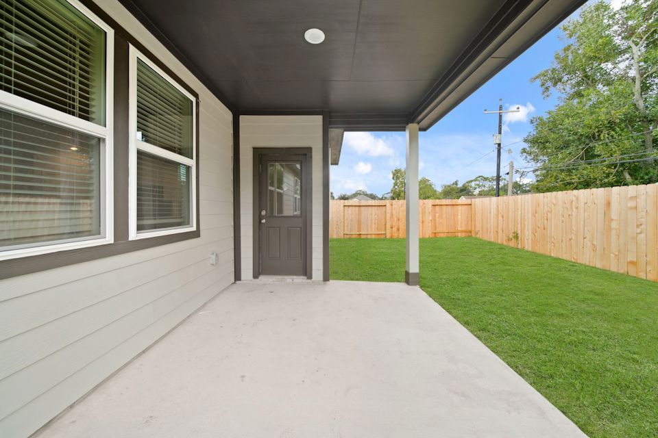 A house with a fence and grass.