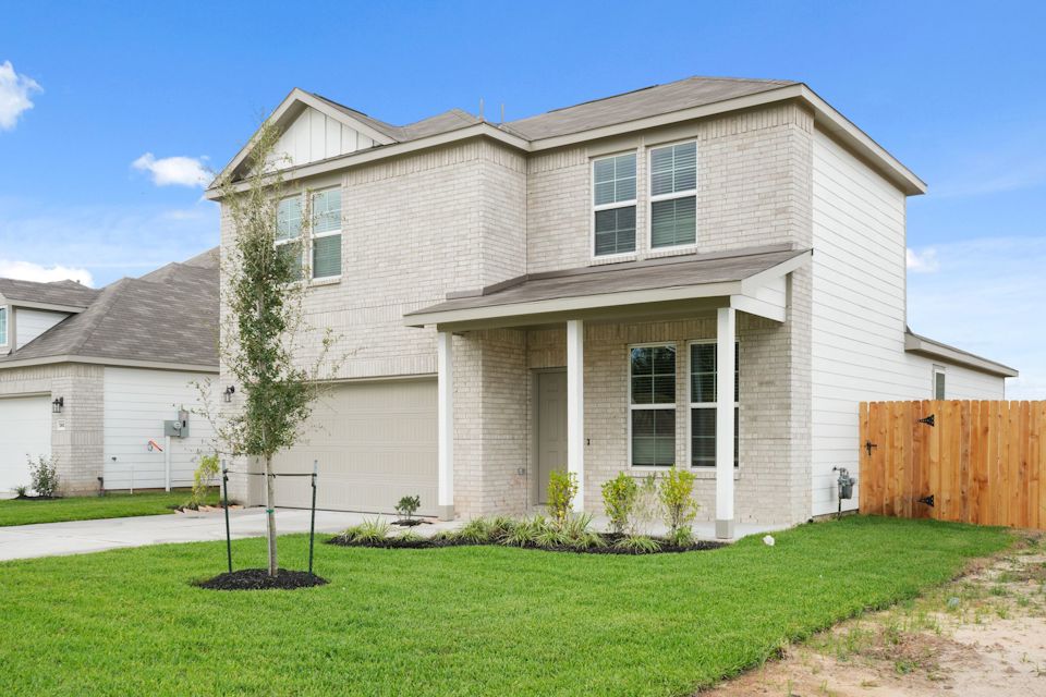 A house with a fence and yard.