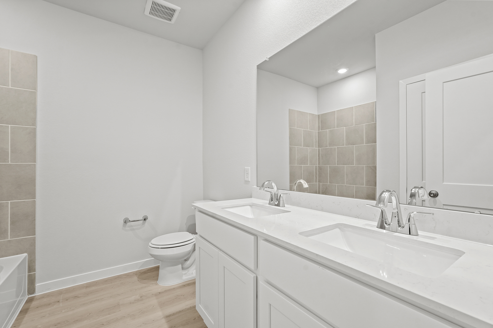 A bathroom with a tub sink and toilet.