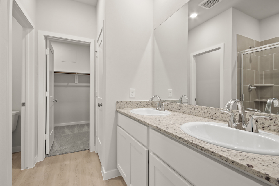 A bathroom with a large mirror.
