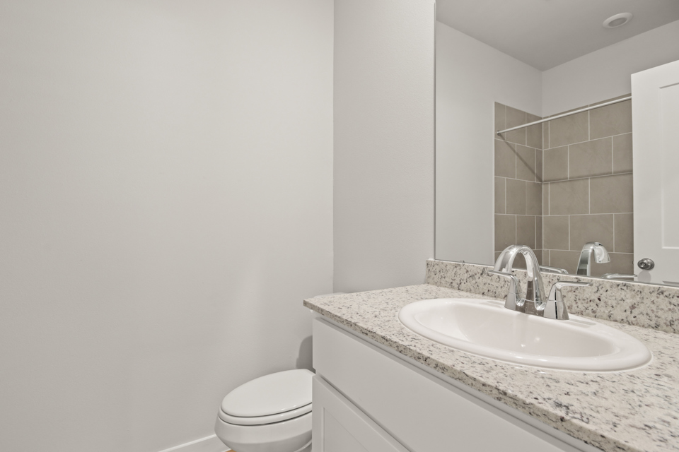 A bathroom with a sink and a toilet.