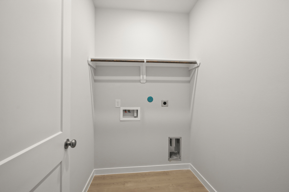 A white wall with a light switch.