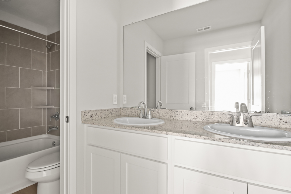 A bathroom with a marble countertop.