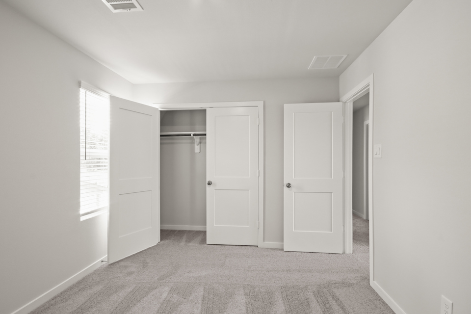 A hallway with white doors.