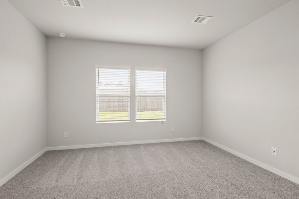 A room with a window and a carpet.