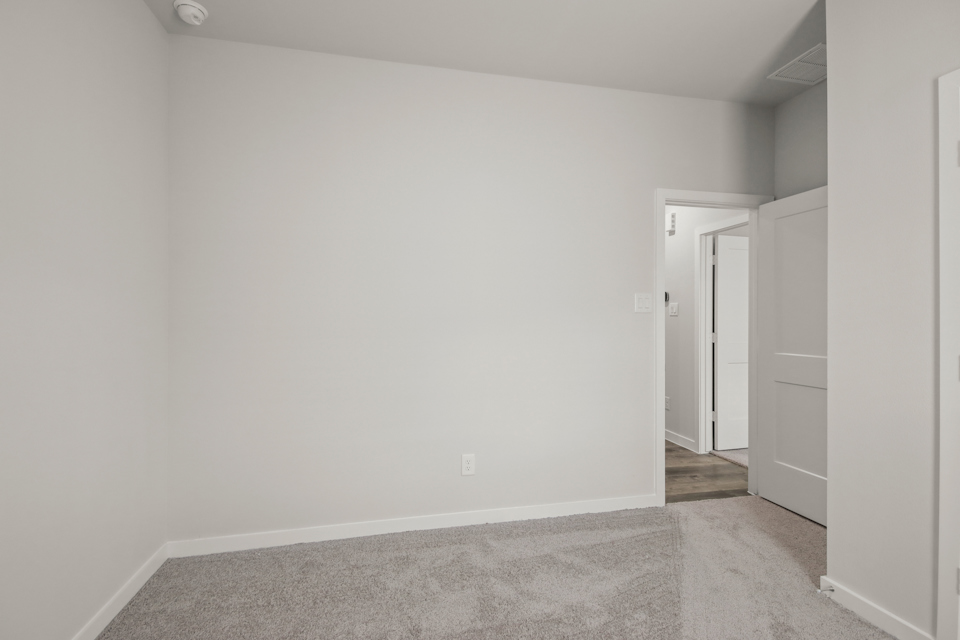 A hallway with white walls.