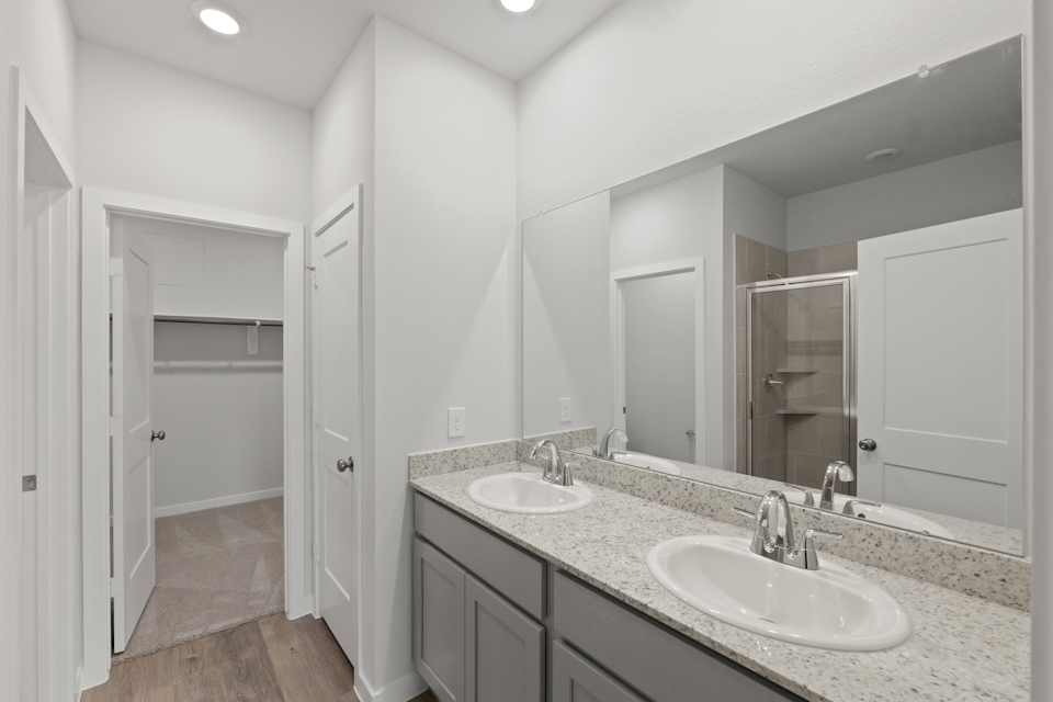 A bathroom with a large mirror.