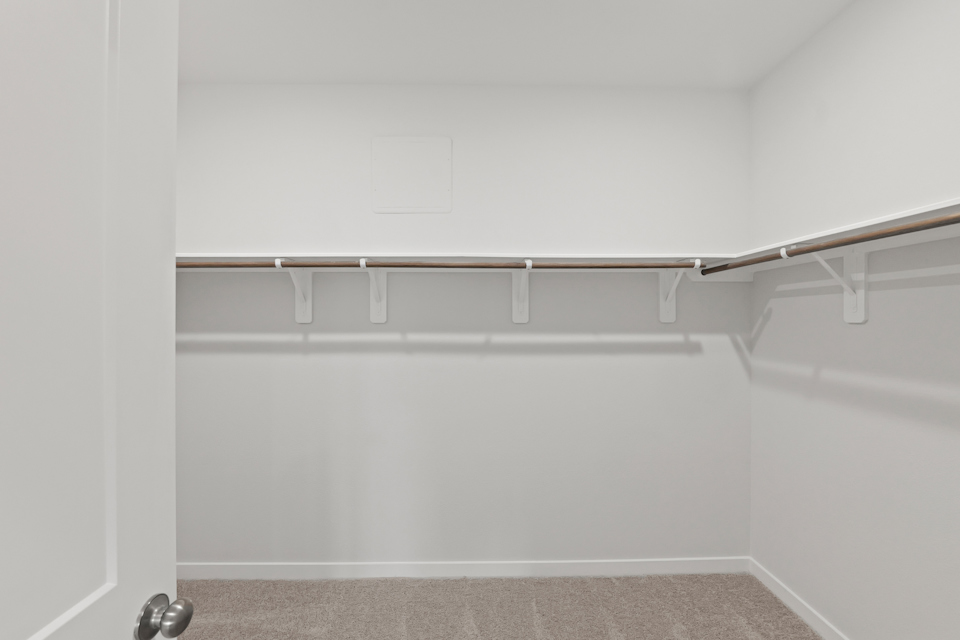 A white wall with a metal bar.