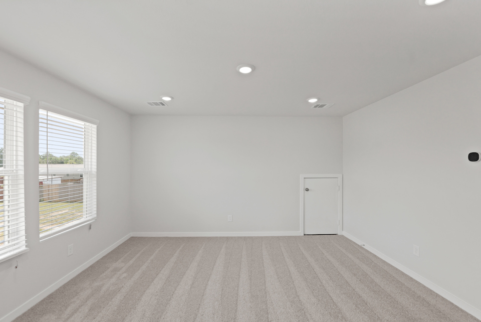 A room with a wood floor and windows.