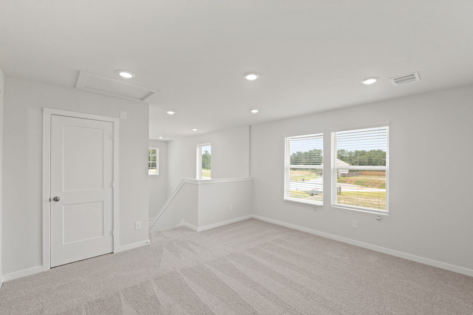 A room with white walls and windows.