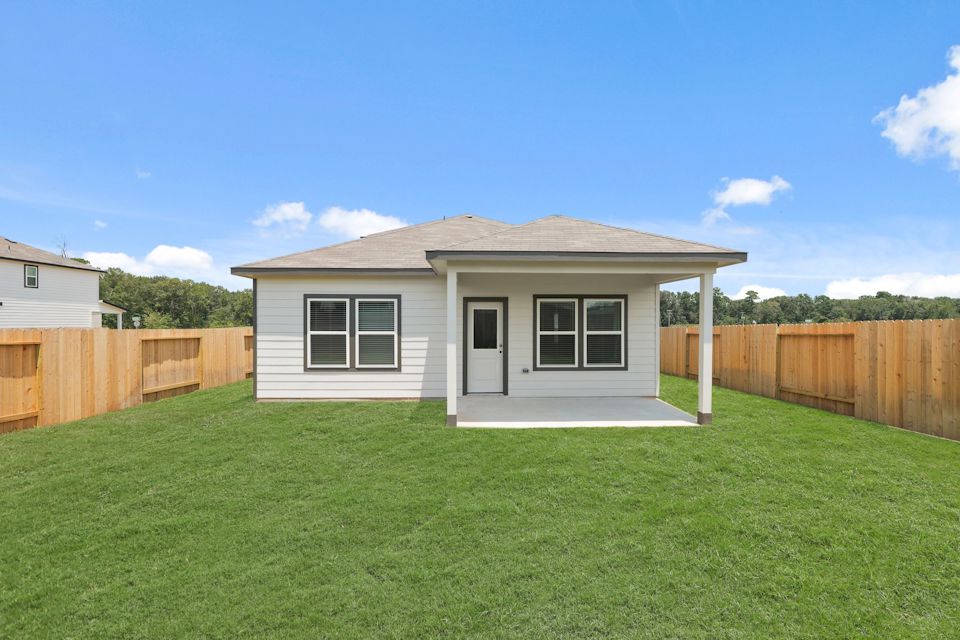 A small house with a fence.