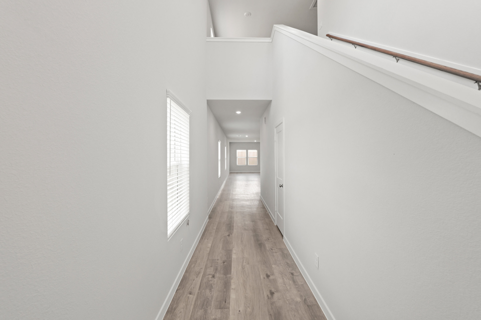 A hallway with white walls.