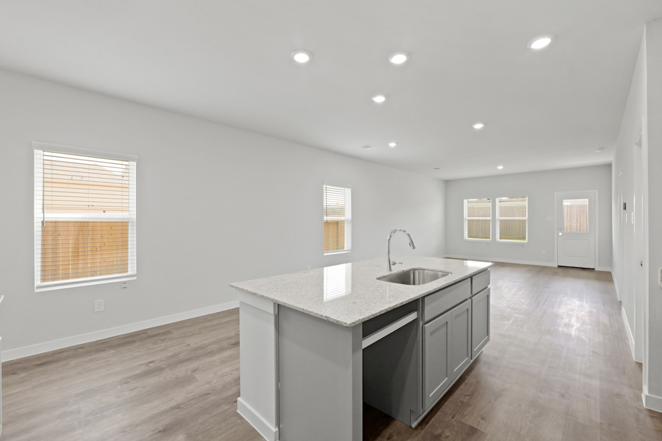 A kitchen with a sink and cabinets.