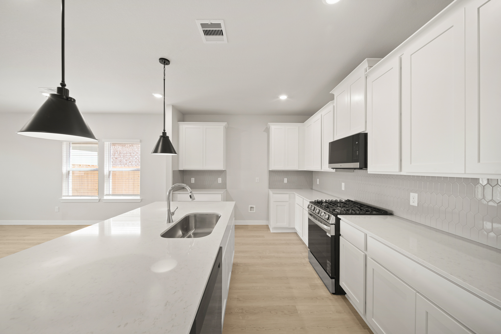 A kitchen with white cabinets.