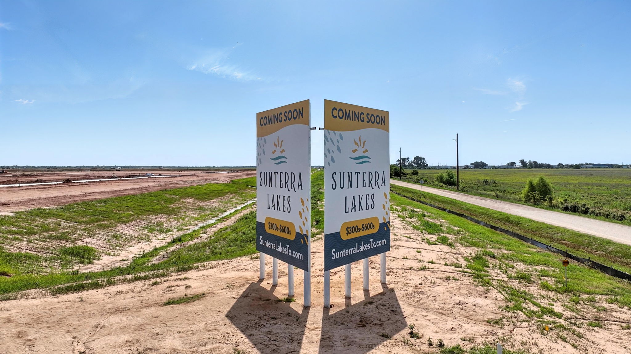 A sign on a dirt road.