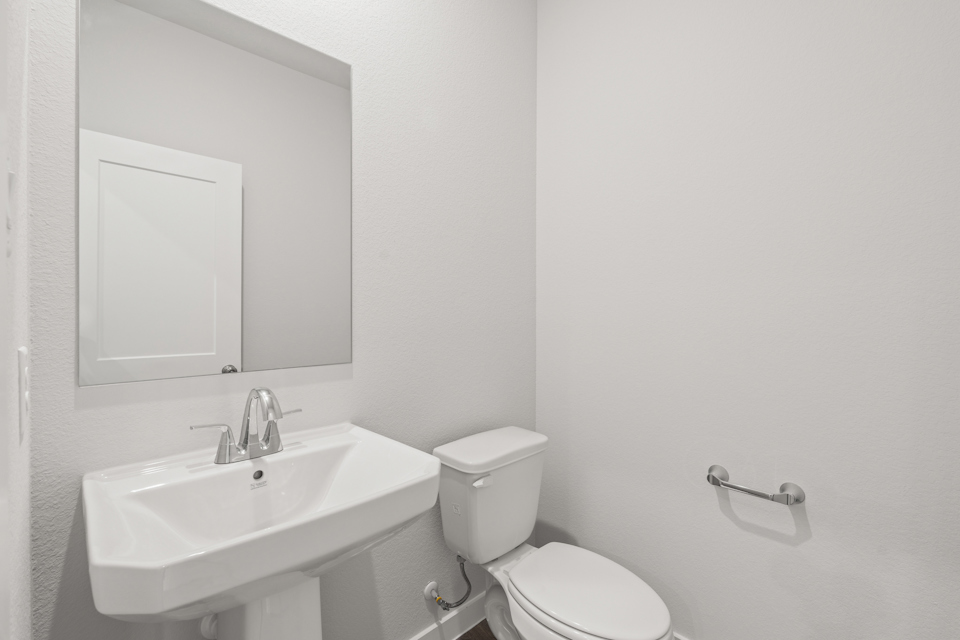 A bathroom with a toilet and sink.