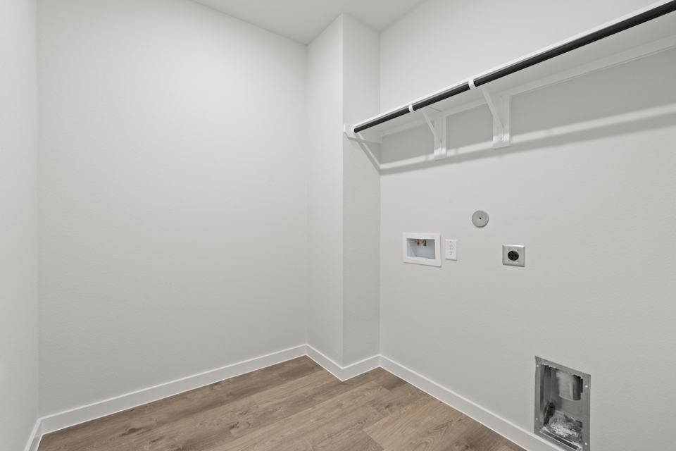 A white room with a wood floor and a white ceiling.
