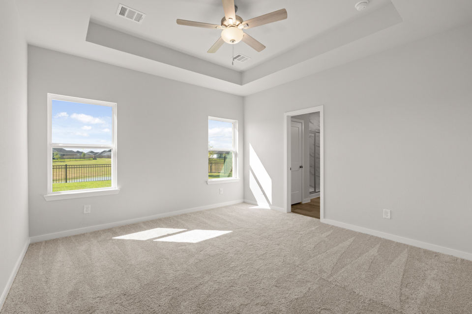 A room with a ceiling fan and a window.