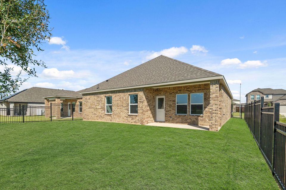 A brick house with a fence around it.