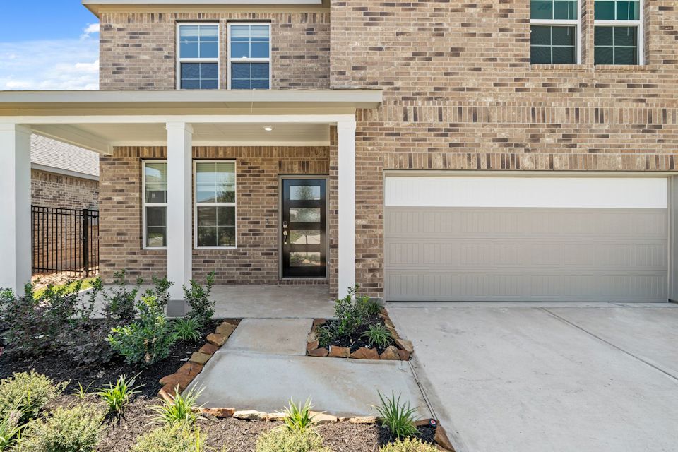 A building with a garage and a door.