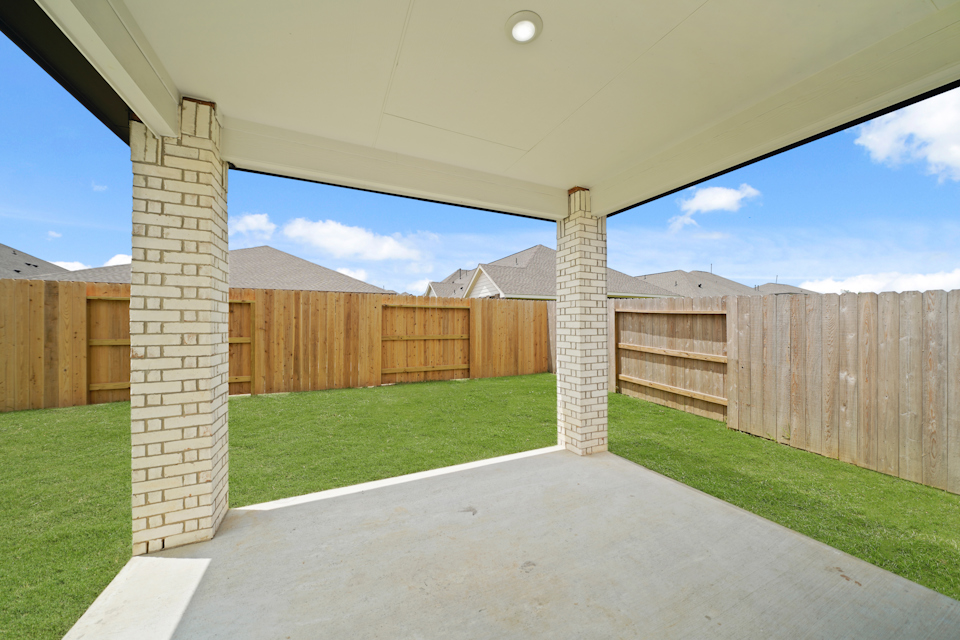 A fenced in area with a stone structure in the middle.