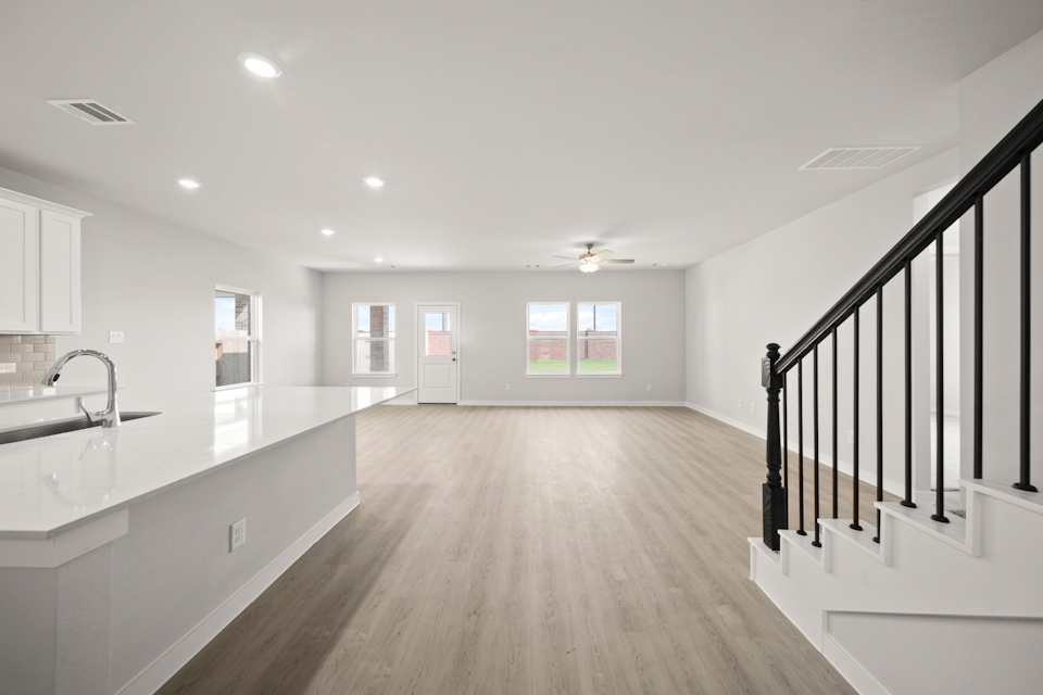 A large bathroom with a wood floor.