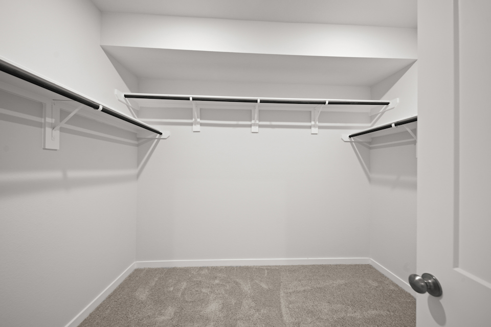 A white room with a grey carpet.