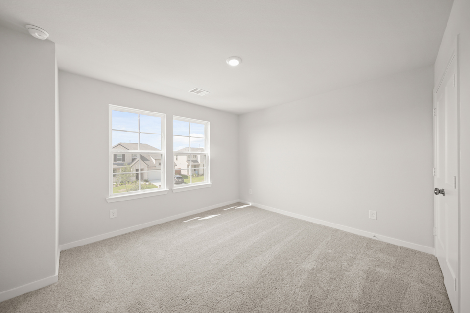 A room with a window and a door.