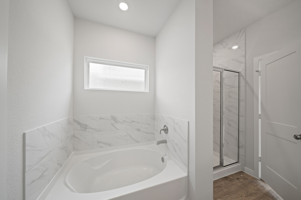 A bathroom with a tub and sink.