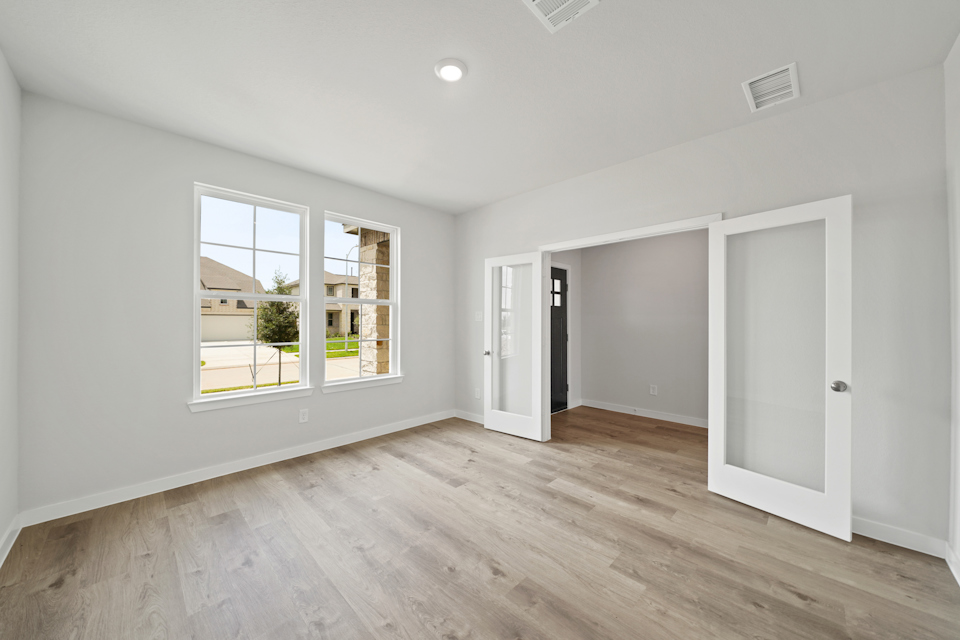 A room with a wood floor and a window.