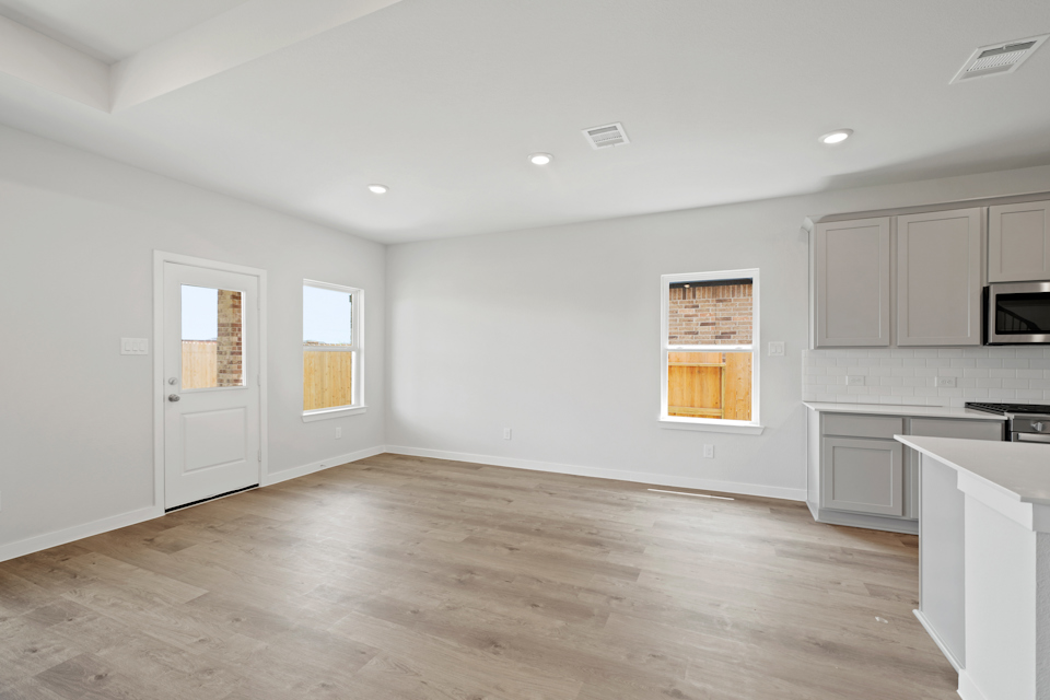 A kitchen with white cabinets.