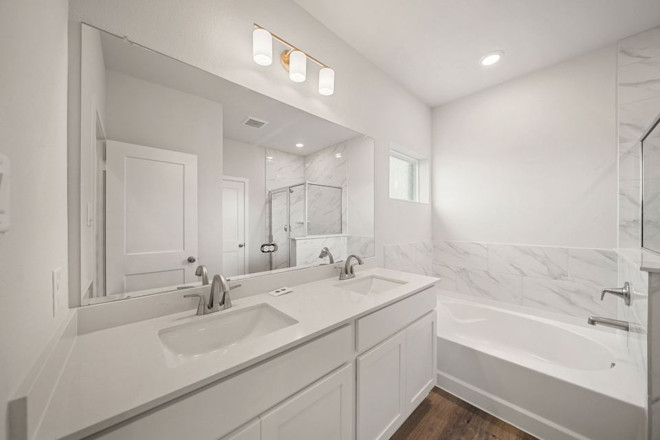 A bathroom with a large mirror.