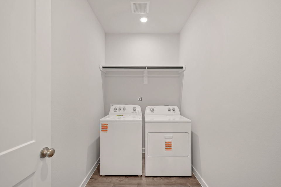A white room with a washing machine.