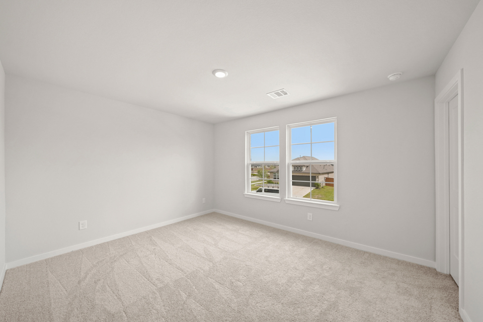 A room with a window and a carpet.