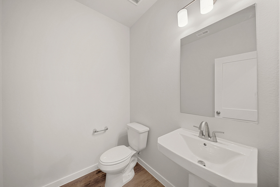 A bathroom with a toilet and sink.