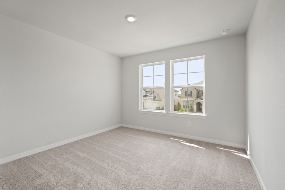 A room with a window and a carpet.