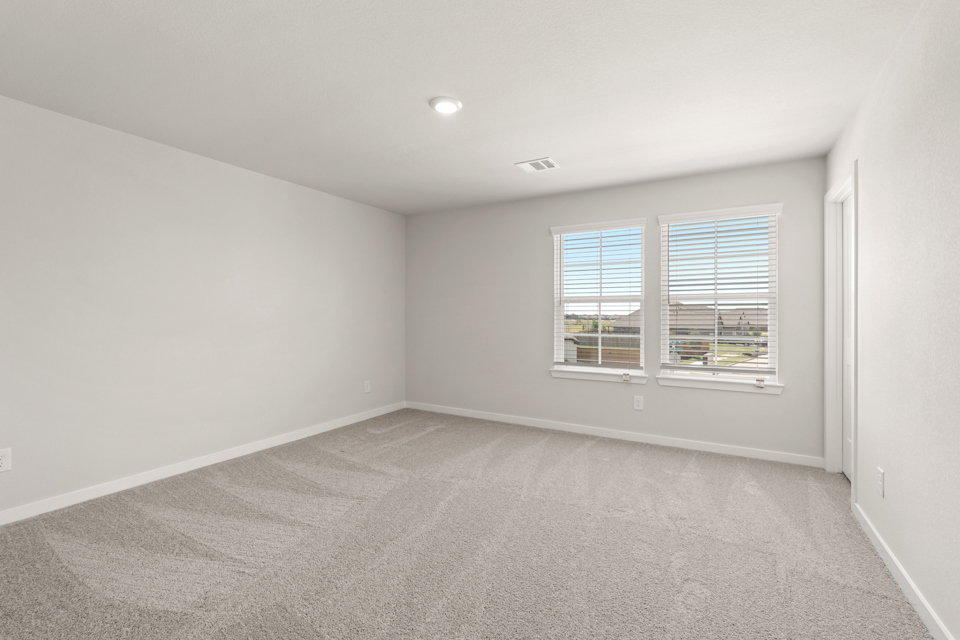 A room with a window and a carpet.