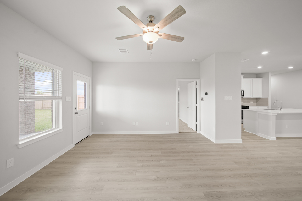 A large kitchen with a ceiling fan.