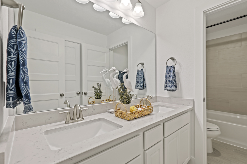 A bathroom with a sink and a mirror.