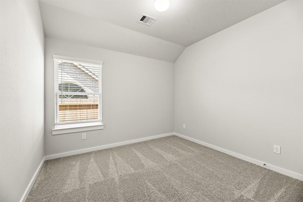 A room with a window and carpet.