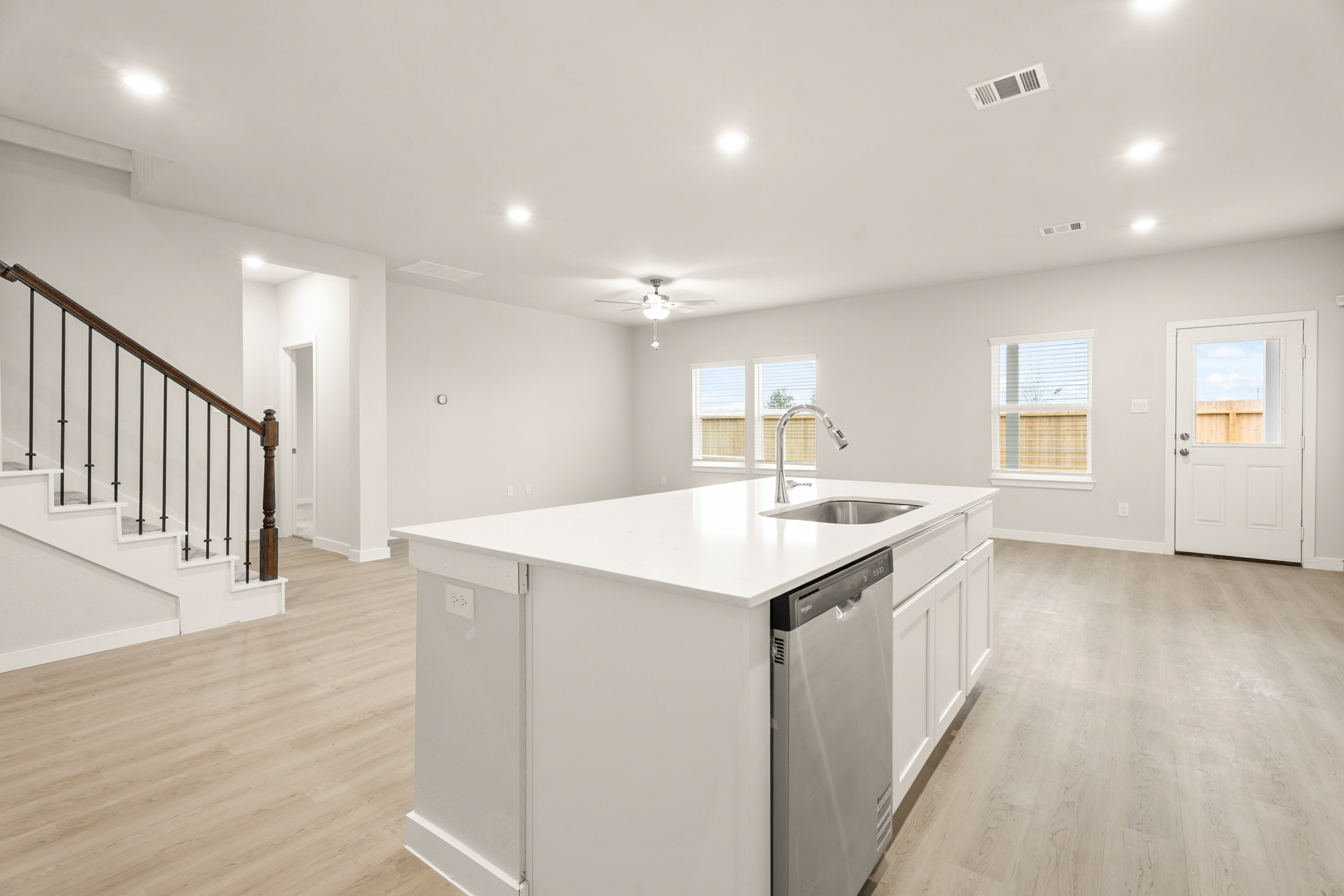A kitchen with white cabinets.