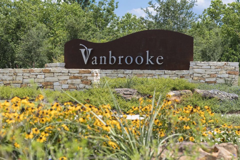 A sign in a garden.