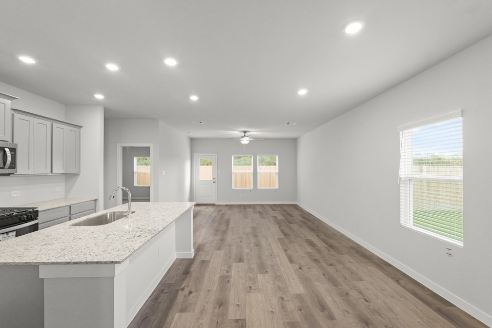 A kitchen with a wood floor.