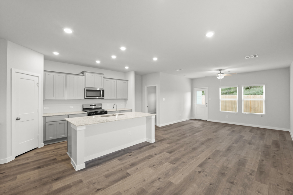 A large kitchen with white cabinets.