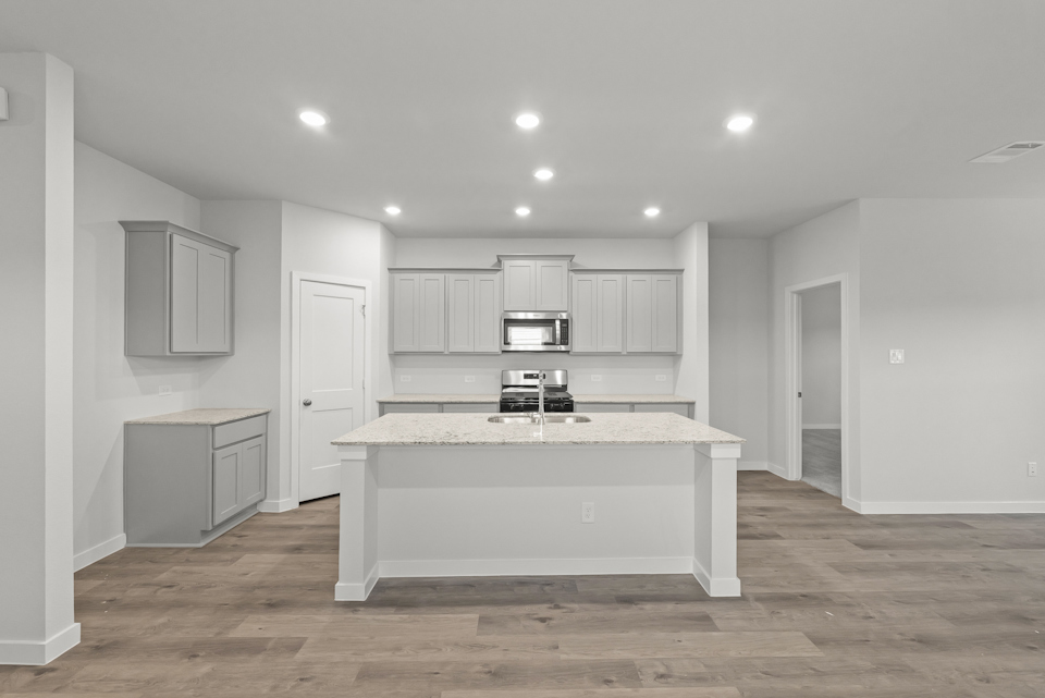 A kitchen with white cabinets.